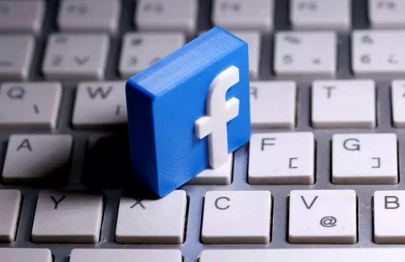 A 3D printed Facebook logo is seen placed on a keyboard in this illustration